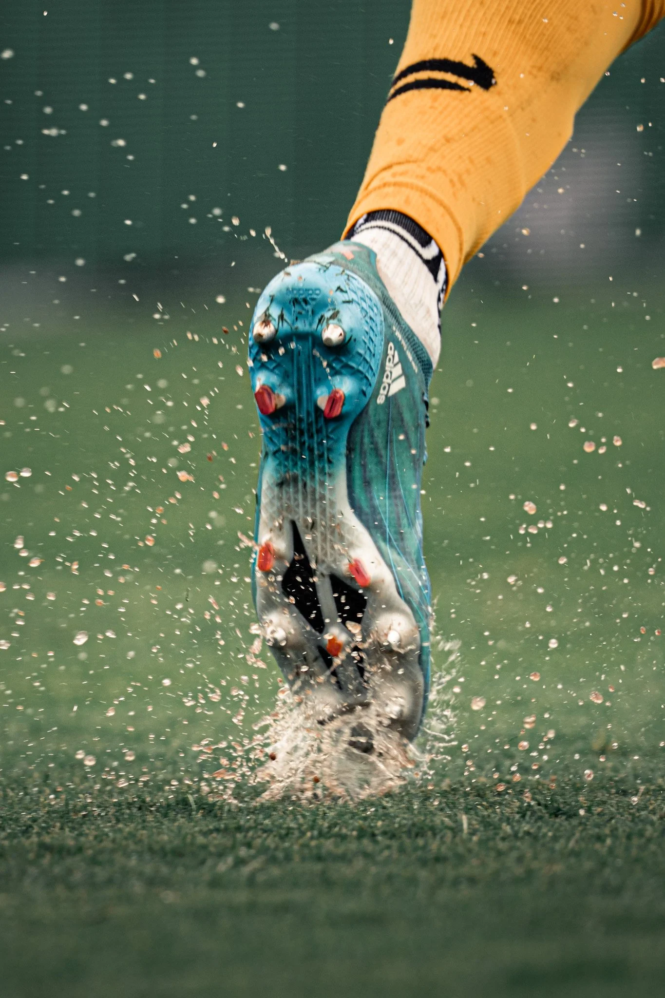 Soccer cleat kicking up water