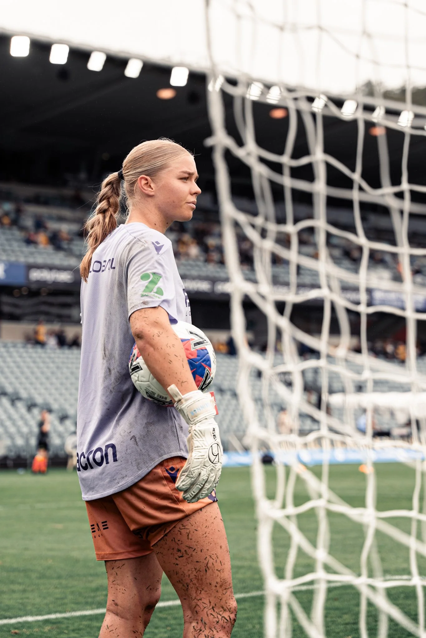 Female goalkeeper holding the ball