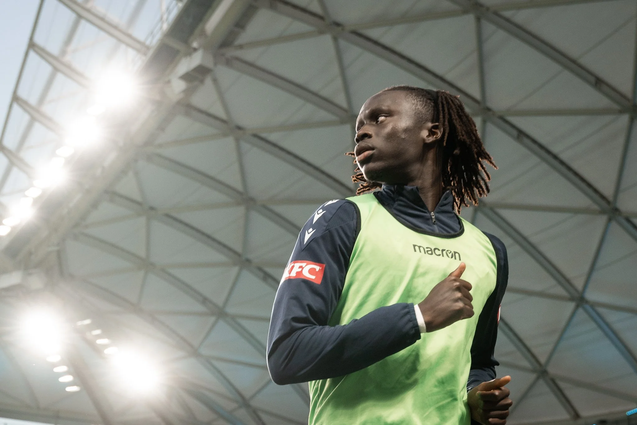 Athlete jogging inside a modern stadium