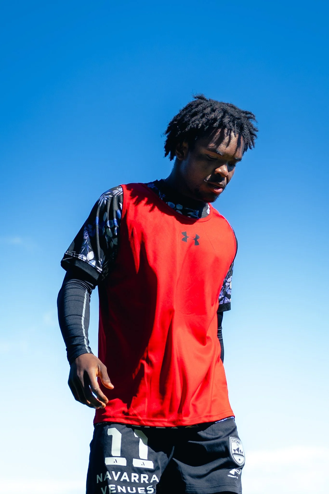 Athlete in red and black against blue sky