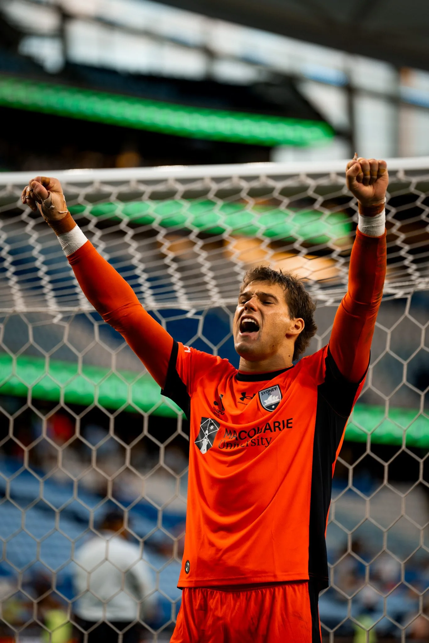 Goalkeeper celebrating with arms raised