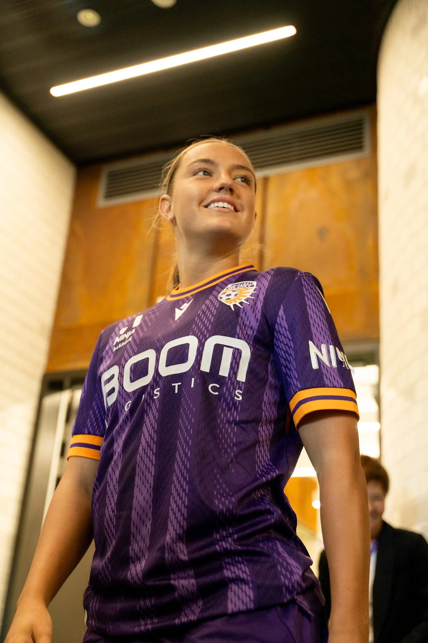 Player in purple and orange smiling