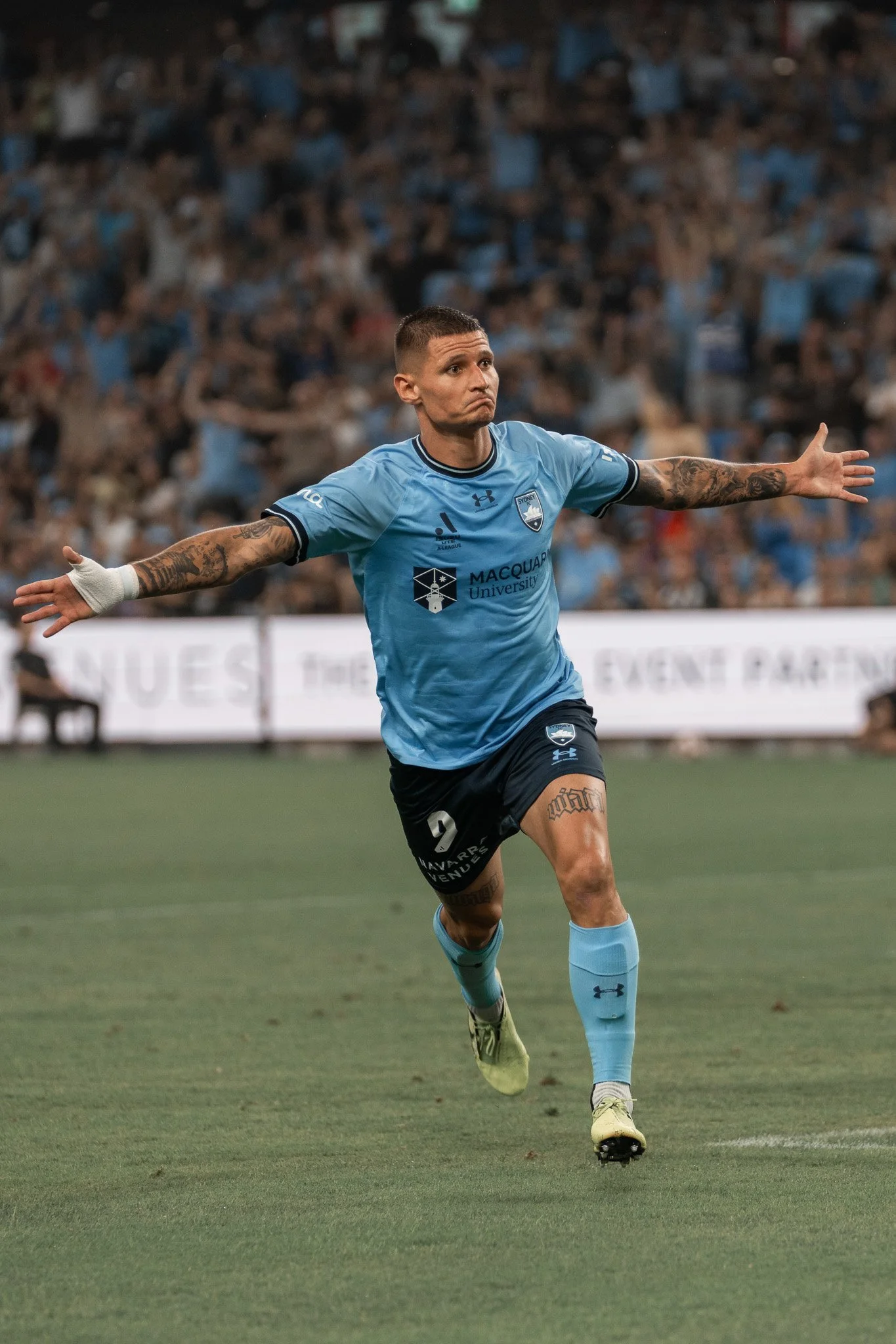 Player in blue celebrating arms outstretched