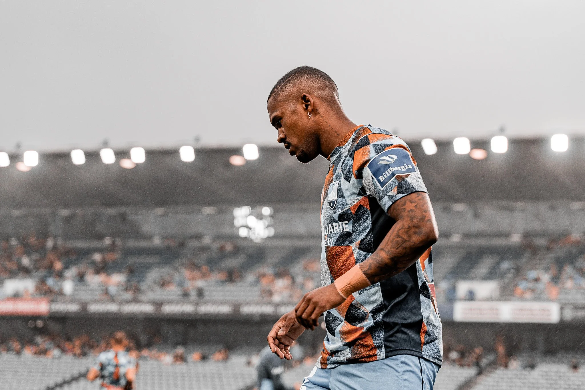 Player walking on the field with cloudy sky
