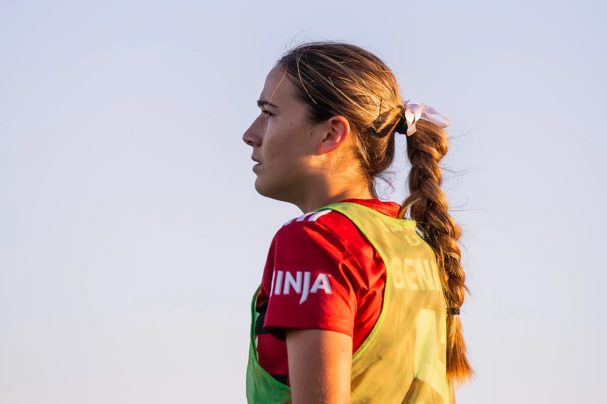 Athlete in red and yellow against clear sky