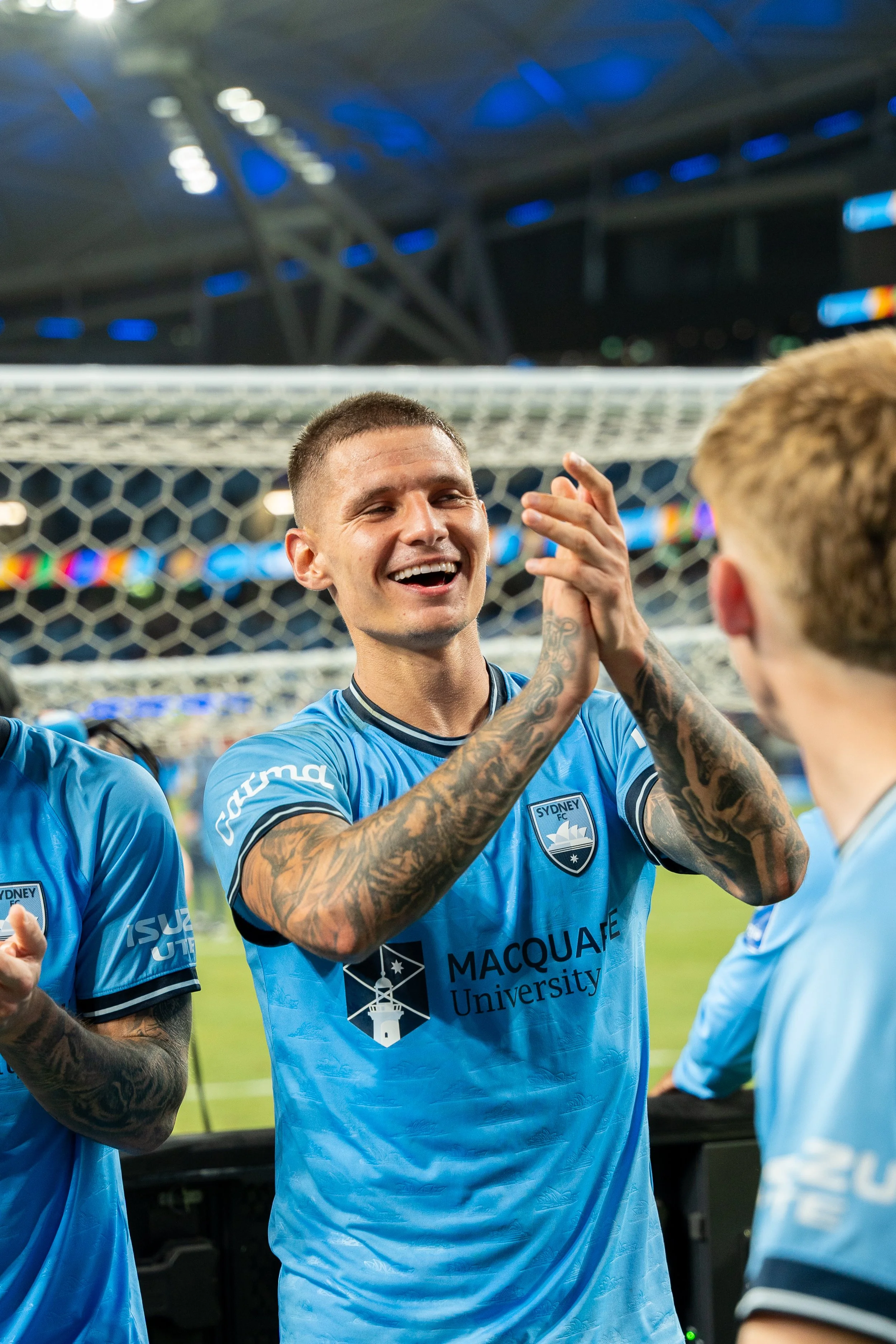 Sydney FC player celebrating with teammate