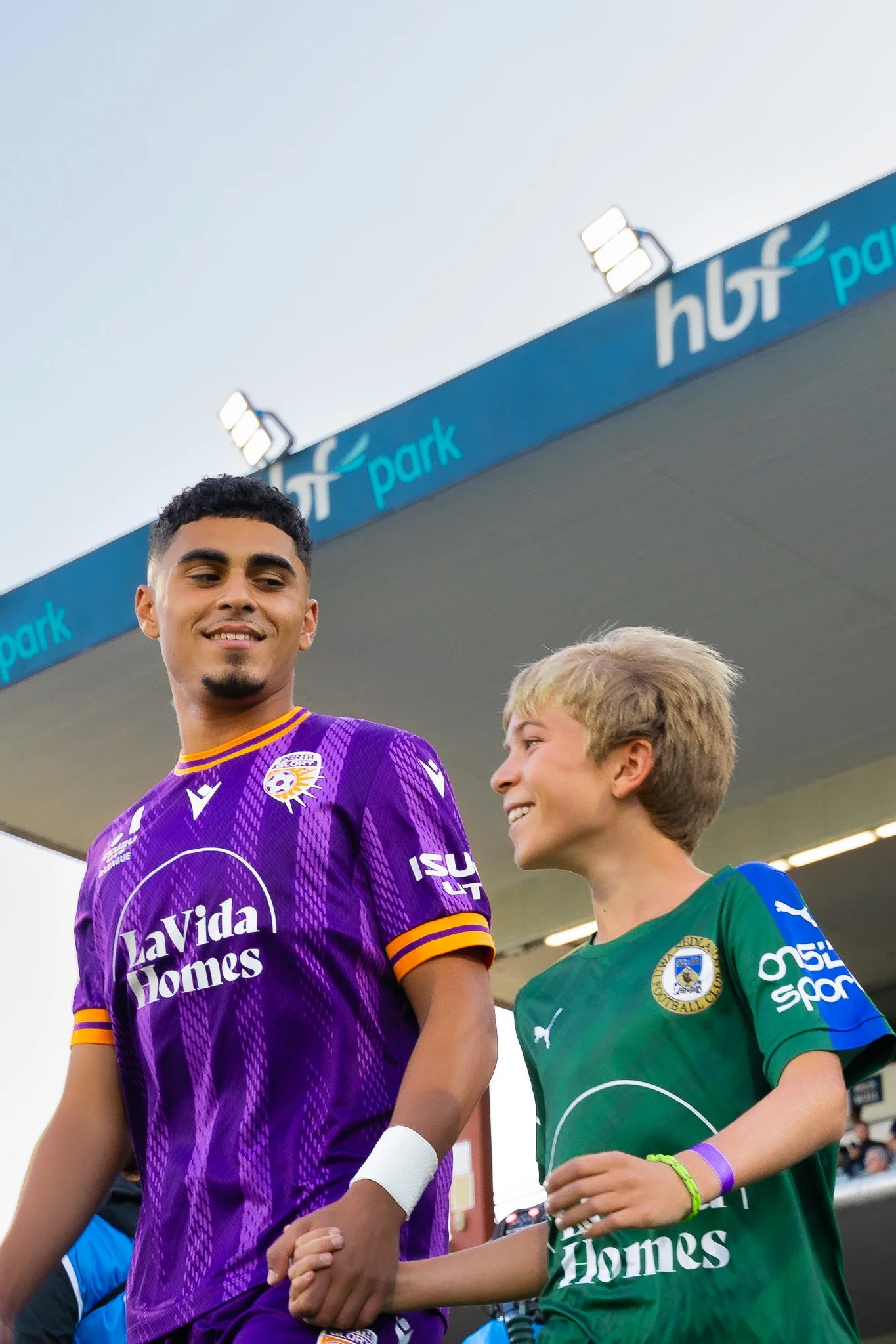Two players standing side by side smiling