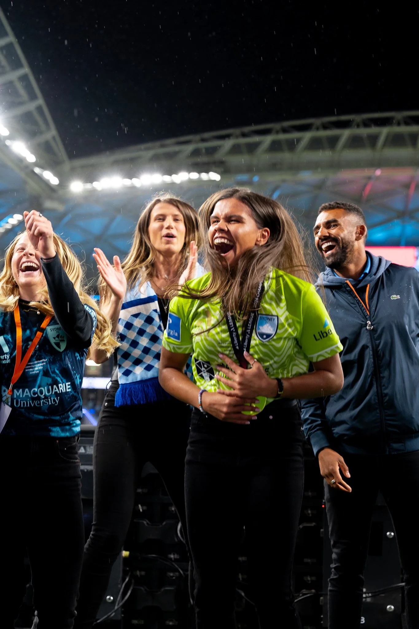 Group celebrating on the field at night