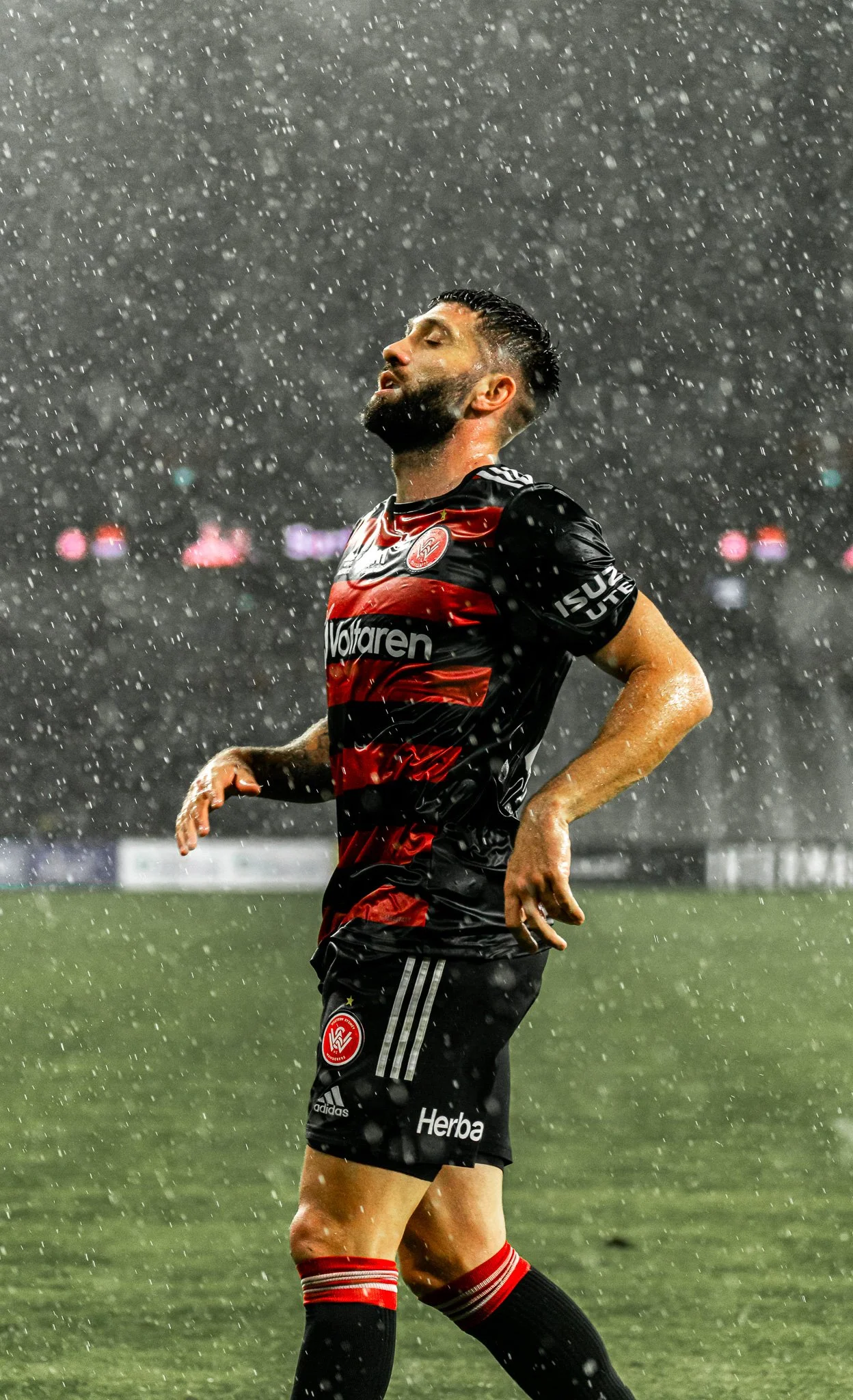 Player standing in the rain on the pitch