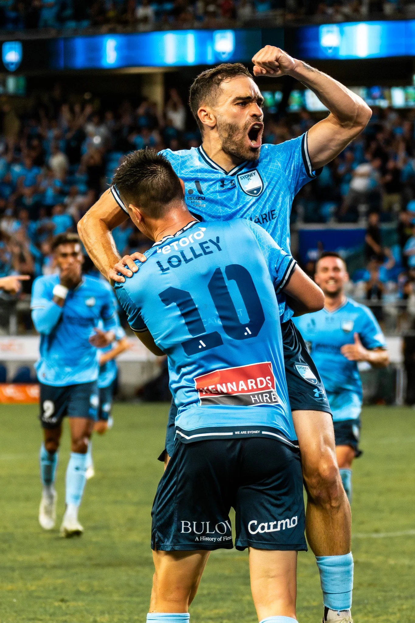 Players in blue celebrating on the field