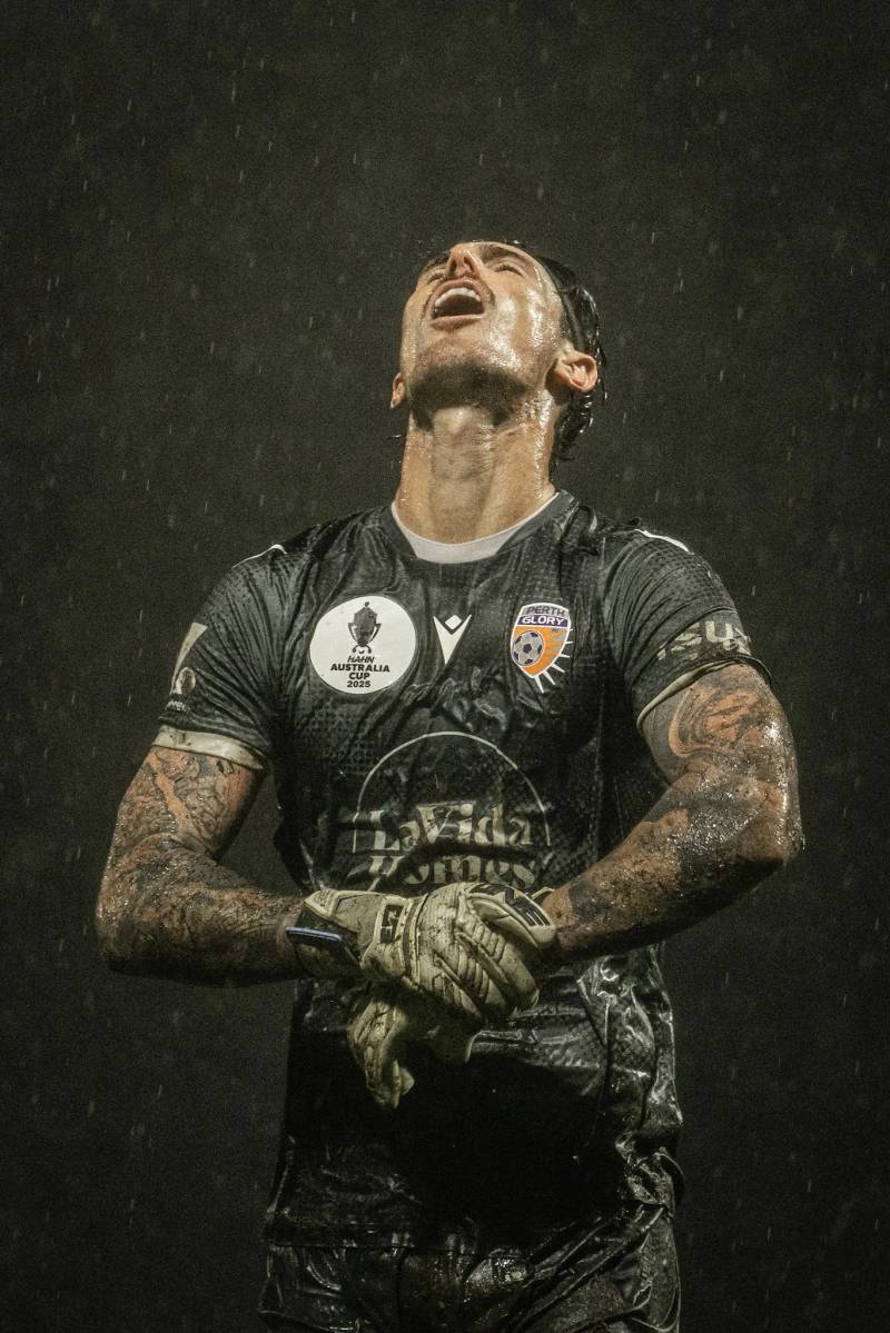 Goalkeeper celebrating in the rain