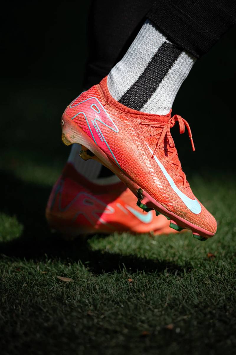 Close-up of a soccer cleat on grass