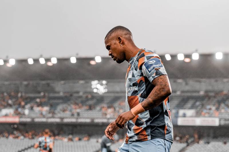 Player walking on the field with cloudy sky