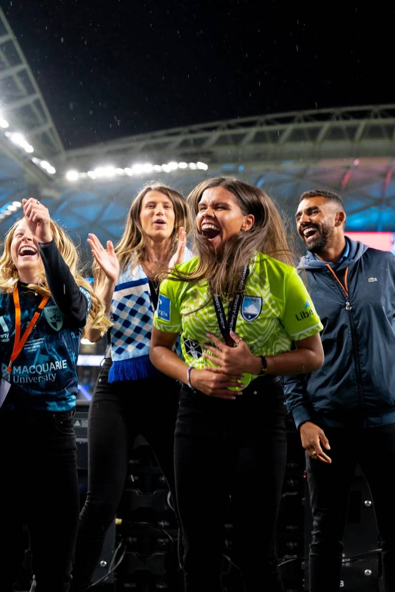 Group celebrating on the field at night